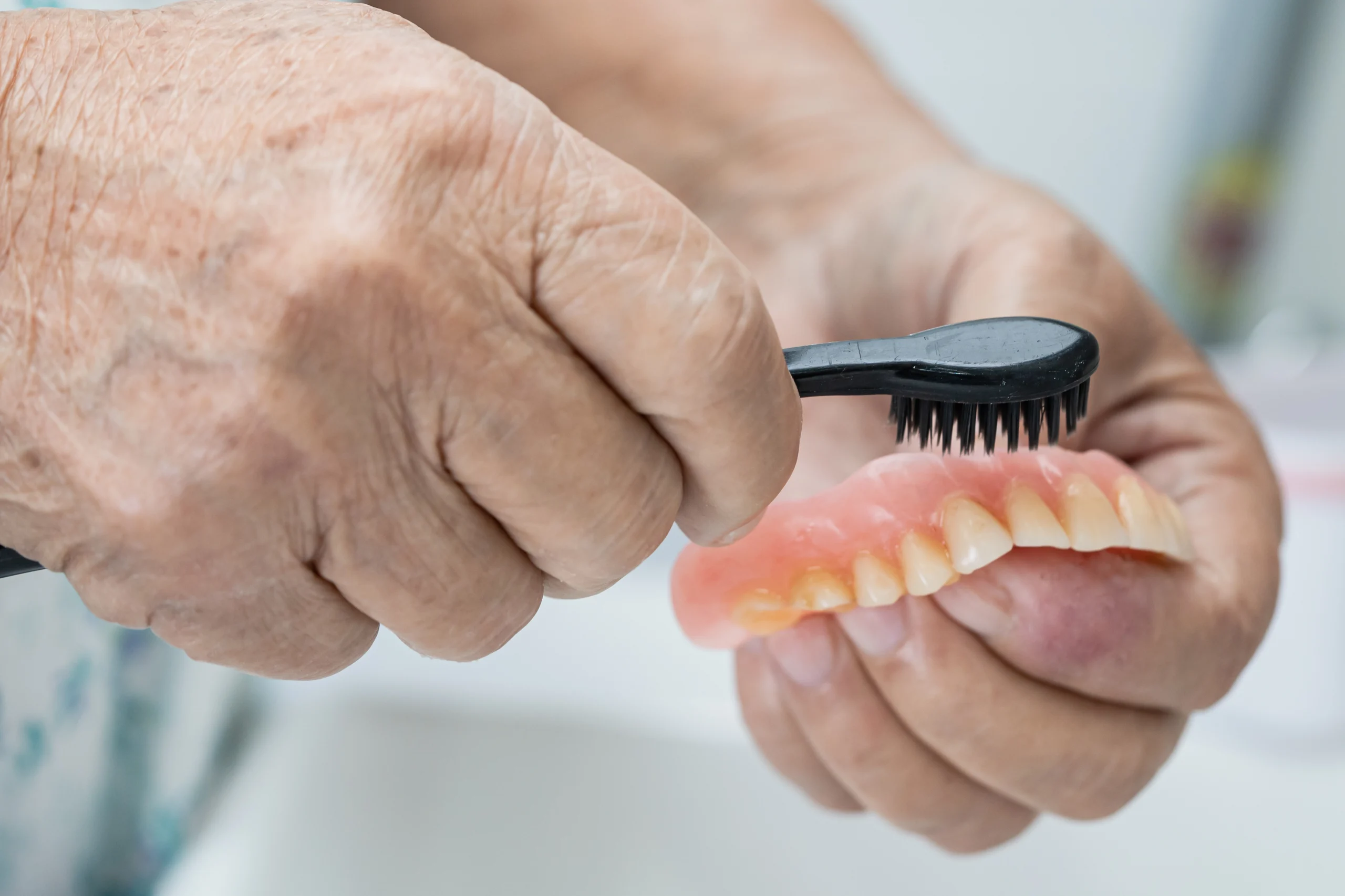 Caring for dentures at Primadent, Liverpool